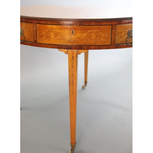 369 - An Edwardian marquetry inlaid satinwood drum top library table, with starburst top inlaid with styli... 