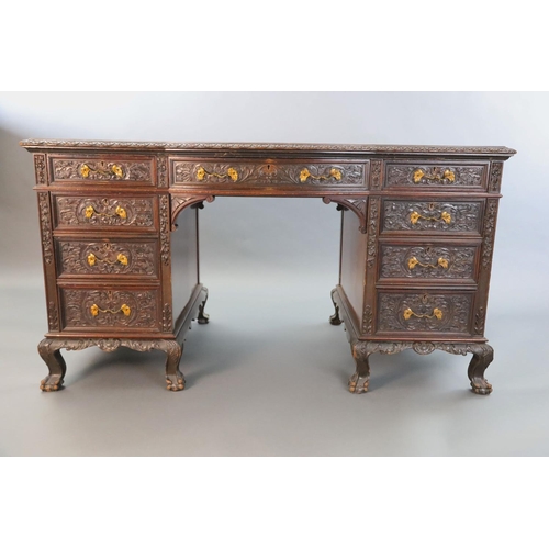 373 - An Edwardian foliate carved mahogany serpentine kneehole desk, with gilt brown skiver, central bowfr... 