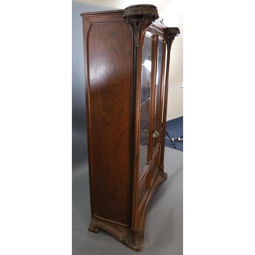 374 - An Art Nouveau walnut and marquetry vitrine by Majorelle, with foliate carved and pierced columns fl... 