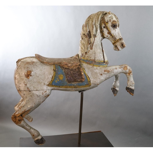 375 - A 19th century, probably American, painted wood carousel horse, upon display stand, the horse with r... 