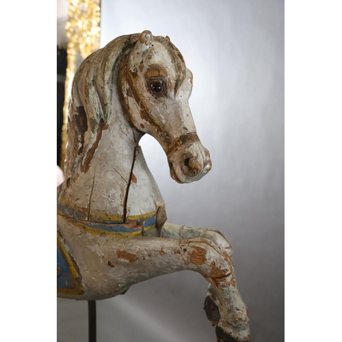 375 - A 19th century, probably American, painted wood carousel horse, upon display stand, the horse with r... 