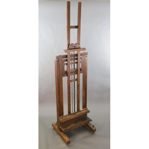 376 - A Roberson & Co oak studio easel, with twin cranked telescopic height adjustment and ivory label giv... 