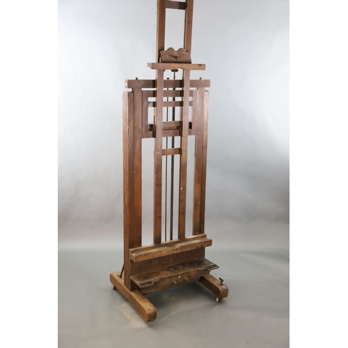 376 - A Roberson & Co oak studio easel, with twin cranked telescopic height adjustment and ivory label giv... 