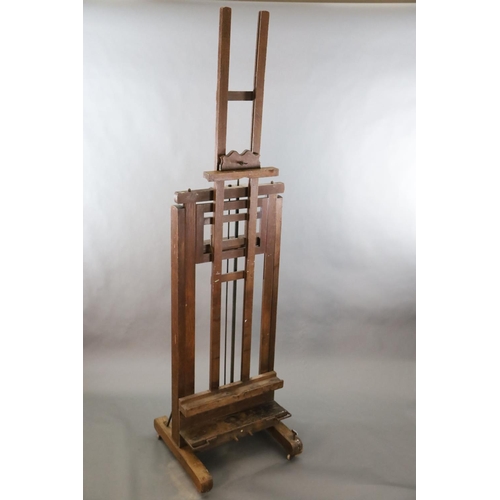 376 - A Roberson & Co oak studio easel, with twin cranked telescopic height adjustment and ivory label giv... 