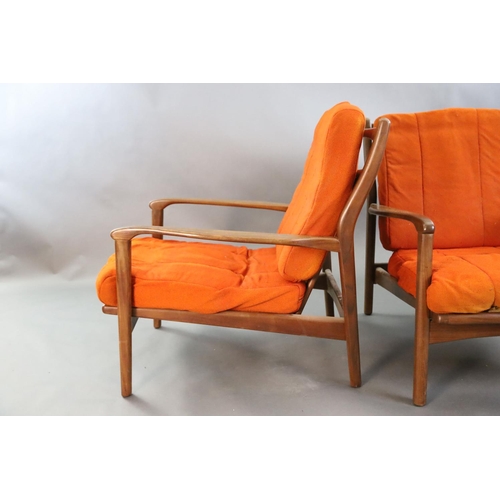 383 - A pair of mid century Danish teak armchairs, with original burnt orange fabric upholstery, W.2ft 2.5... 