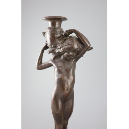 39 - After Edward Francis McCartan (1879-1947). A pair of Art Nouveau bronze candlesticks, modelled as nu... 