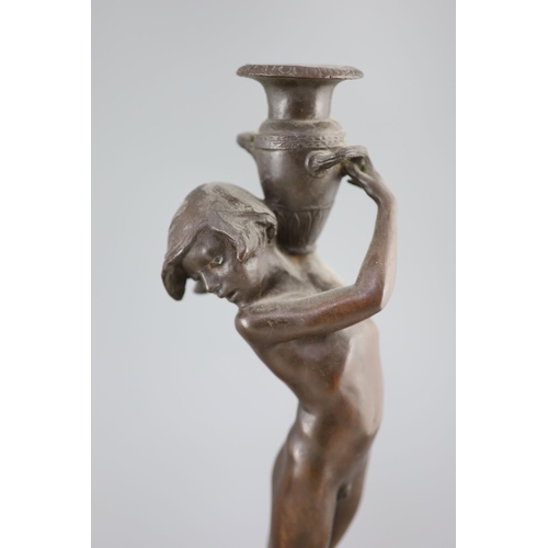 39 - After Edward Francis McCartan (1879-1947). A pair of Art Nouveau bronze candlesticks, modelled as nu... 