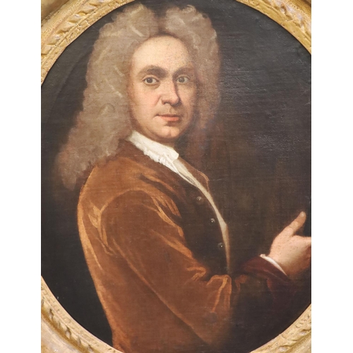 398 - School of Sir Godfrey Kneller (1646-1723)oil on canvasPortrait of a gentleman holding a set of drawi... 