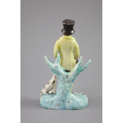 44 - A Staffordshire pearlware group of a huntsman with dog and gun, c.1820-30, on a turquoise and blue h... 