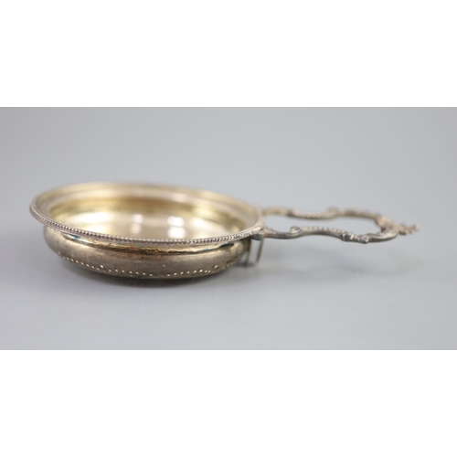 488 - A George III silver single handled lemon strainer, London, 1779, with ornate scroll handle and beade... 