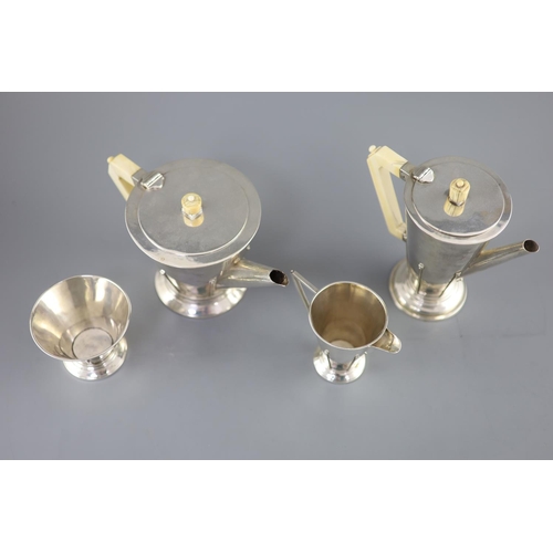 498 - A stylish 1930's Art Deco silver four piece tea and coffee service by Charles Boyton, of conical for... 