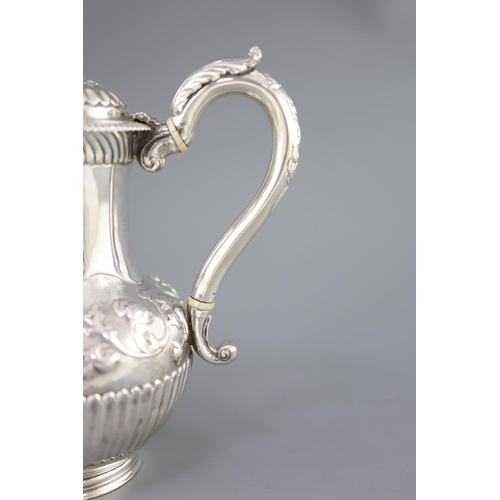 502 - A Victorian silver coffee pot by Richard Sibley II, of baluster form, with acanthus leaf capped hand... 