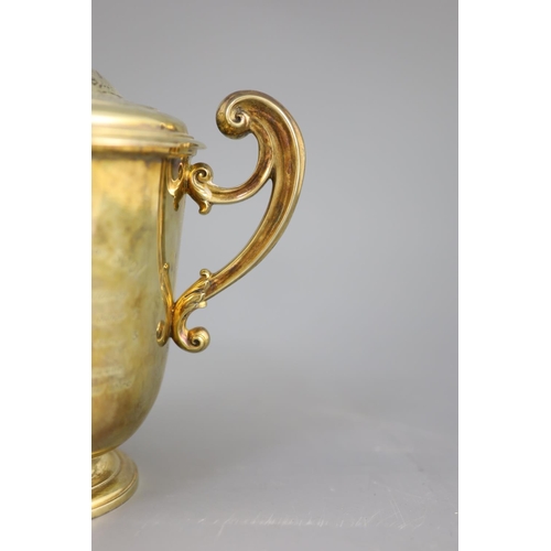 506 - An Edwardian silver gilt-lidded two handled presentation cup and cover, by R & S Garrard and Co. wit... 