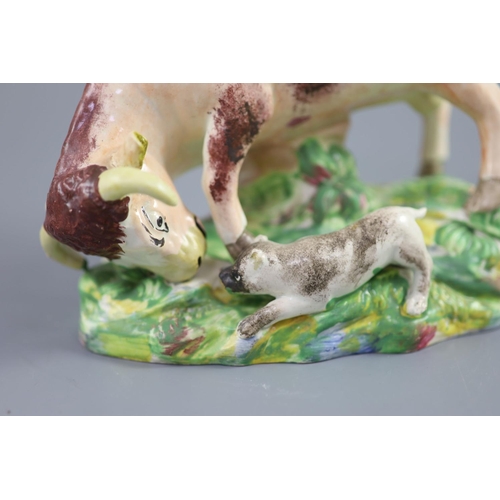 52 - Enoch Wood of Burslem, a pearlware group 'Bull baiting', c.1800-10, the bull standing before bocage ... 