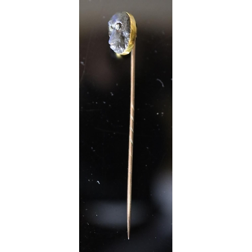 527 - A Victorian gold mounted diamond set labradorite? stick pin, carved as the head of an ape, 78mm, gro... 