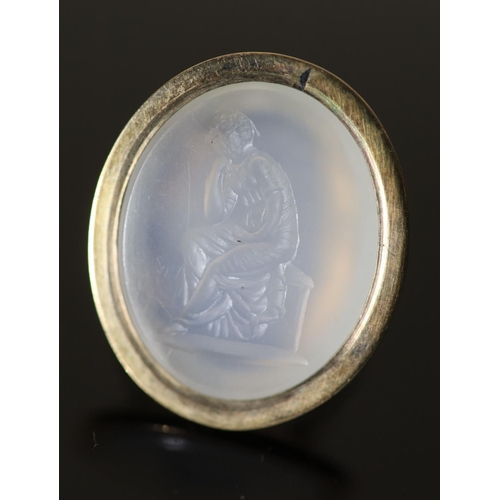 530 - An early 19th century gold and white agate oval intaglio ring, carved with a seated figure, size M, ... 