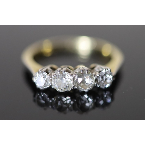 559 - An early 20th century 18ct gold, platinum and graduated four stone diamond ring, size O, gross 3.6 g... 