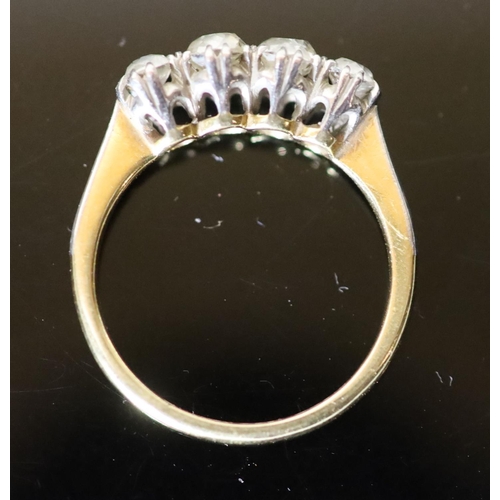 559 - An early 20th century 18ct gold, platinum and graduated four stone diamond ring, size O, gross 3.6 g... 