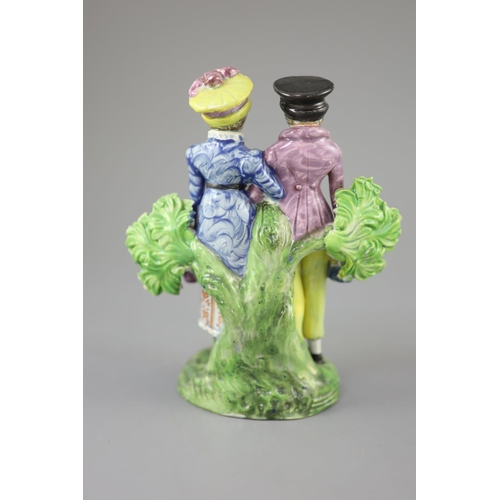 57 - A Staffordshire pearlware group of a Dandy and Dandizette with seated dog, c.1820-30, each standing ... 