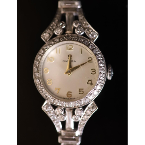 575 - A lady's early 1960's 18ct gold, palladium and diamond set Omega manual wind cocktail watch, on diam... 