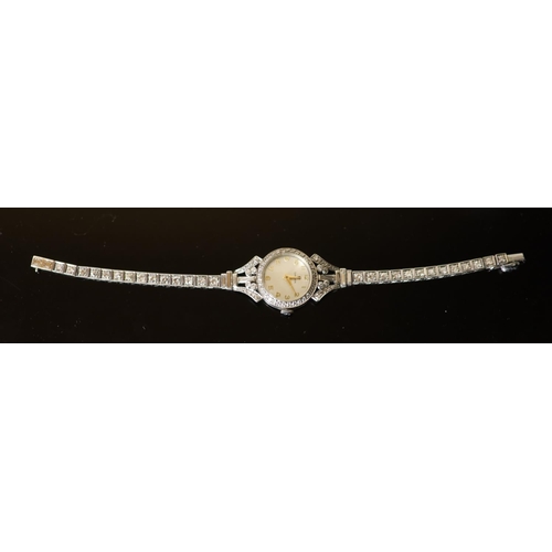 575 - A lady's early 1960's 18ct gold, palladium and diamond set Omega manual wind cocktail watch, on diam... 