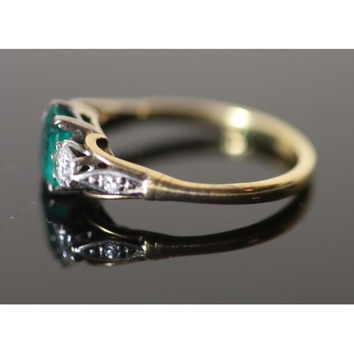 577 - An 18ct gold, emerald and diamond set three stone ring, with diamond set shoulders, size M/N, gross ... 