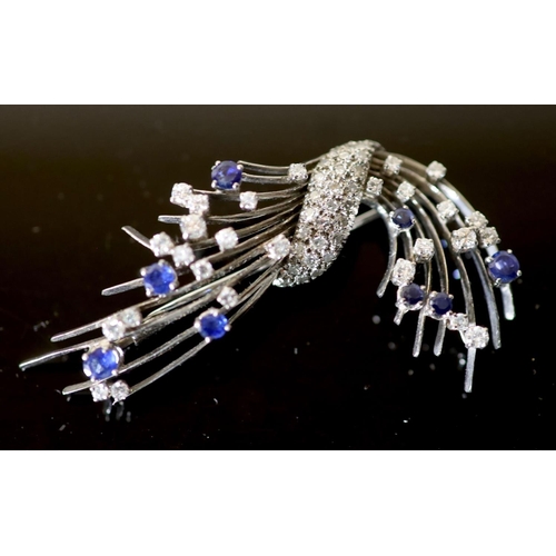 582 - A platinum?, diamond and sapphire set spray brooch, set with round cut stones, 65mm, gross 19.3 gram... 