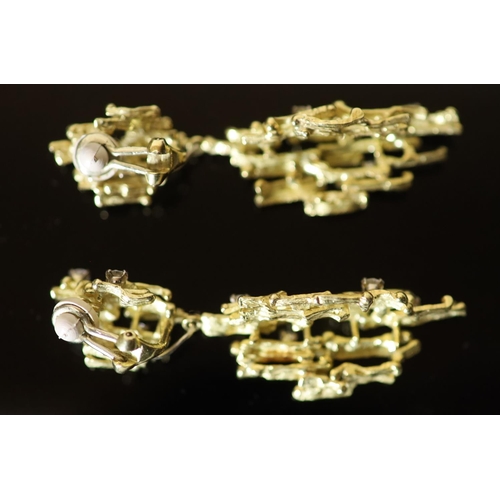 587 - A pair of early 1970's 18ct gold and seven stone diamond set modernist rustic drop ear clips, by Ala... 