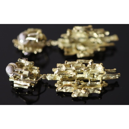 587 - A pair of early 1970's 18ct gold and seven stone diamond set modernist rustic drop ear clips, by Ala... 