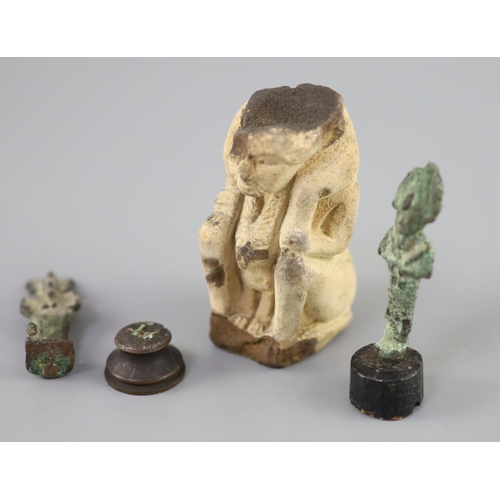 6 - Two Egyptian bronze statuettes of Osiris and a sculpted limestone figure fragment, Ptolemaic period,... 