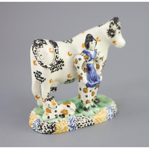 61 - A Yorkshire Prattware 'cow and milkmaid' group, probably Mexborough, c.1820, with sponged decoration... 