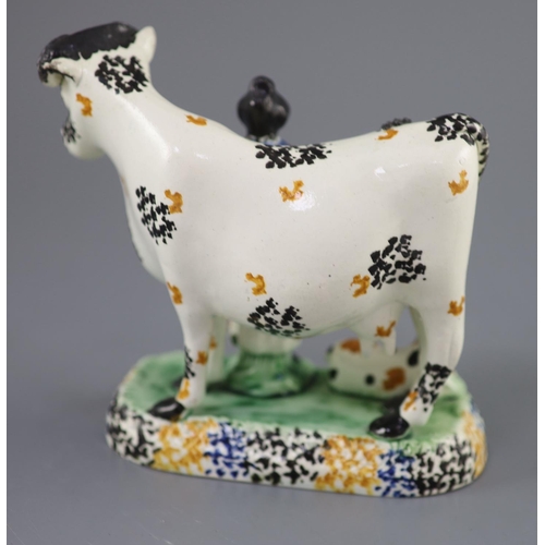 61 - A Yorkshire Prattware 'cow and milkmaid' group, probably Mexborough, c.1820, with sponged decoration... 