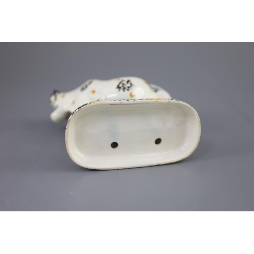 61 - A Yorkshire Prattware 'cow and milkmaid' group, probably Mexborough, c.1820, with sponged decoration... 