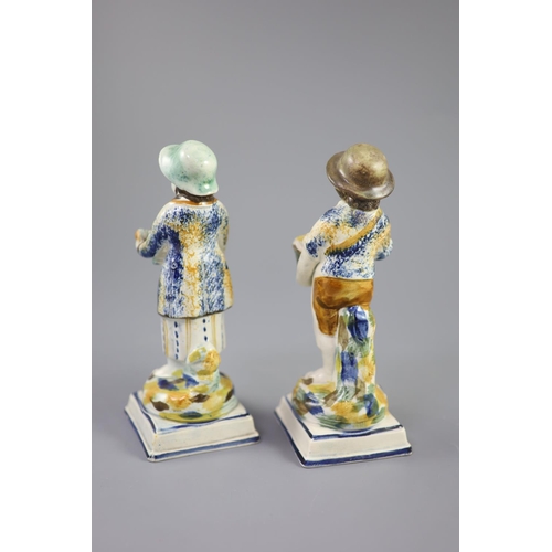 66 - A pair of Prattware figures of fruit and biscuit street vendors, c.1790-1800, on square bases, pearl... 