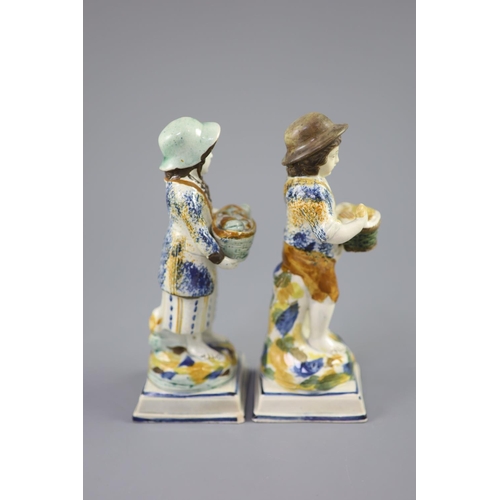 66 - A pair of Prattware figures of fruit and biscuit street vendors, c.1790-1800, on square bases, pearl... 