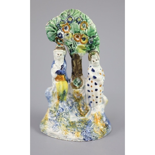 69 - A Staffordshire Prattware 'Toy' group, c.1790-1800, moulded with two figures each side of bocage and... 