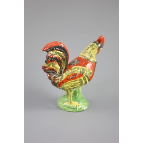 73 - A Staffordshire pearlware figure of a cockerel, c.1820, on a naturalistic mound base, 19cm highCONDI... 