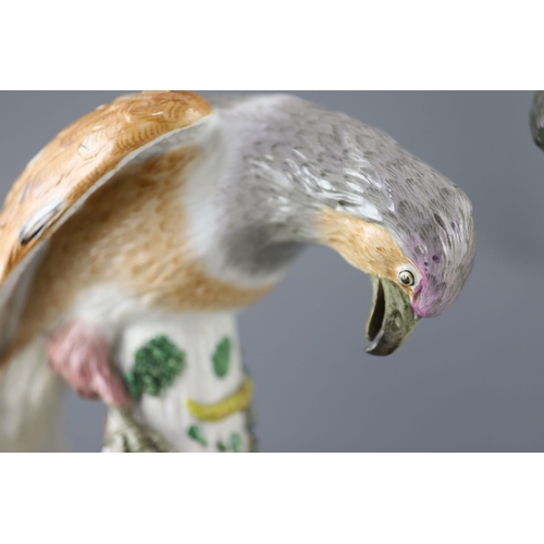 85 - A pair of large German porcelain models of raptors, late 19th century, each seated upon a tree stump... 