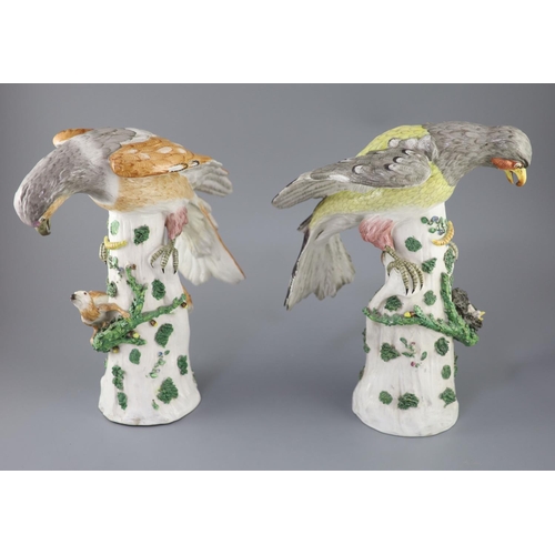 85 - A pair of large German porcelain models of raptors, late 19th century, each seated upon a tree stump... 