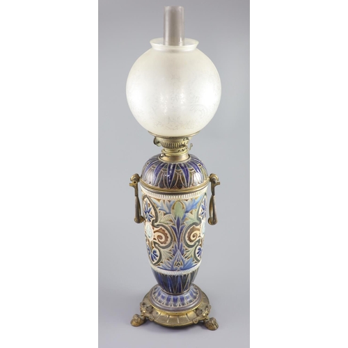 96 - A large Doulton Lambeth stoneware oil lamp, by Edith D. Lupton, dated 1880, decorated with cherub he... 