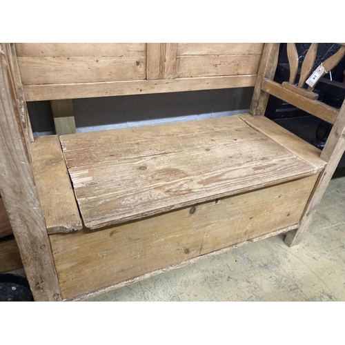 14 - A 19th century East European pine box seat settle, length 110cm, depth 50cm, height 98cm