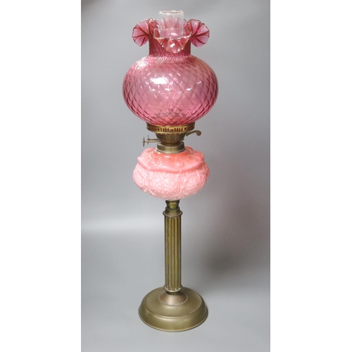 426 - A Victorian brass and pink glass oil lamp, height 70cm