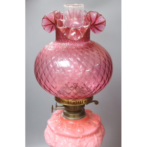 426 - A Victorian brass and pink glass oil lamp, height 70cm