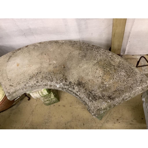 12 - A reconstituted stone curved garden seat, length 110cm, depth 44cm, height 44cm