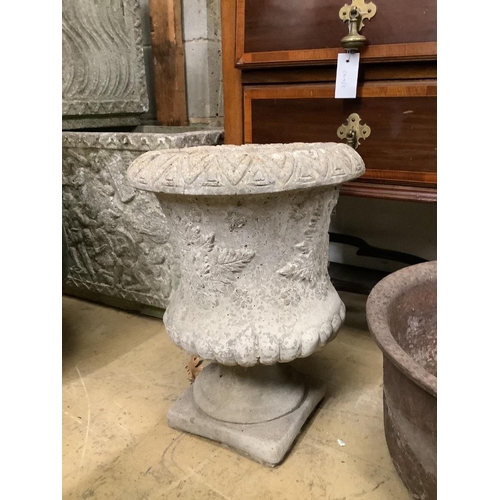 148 - A reconstituted stone planter, height 44cm on base together with a circular cast iron garden planter... 