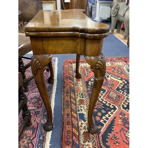 156 - A Queen Anne revival walnut concertina folding card table, stamped Gill and Reigate, London retailed... 