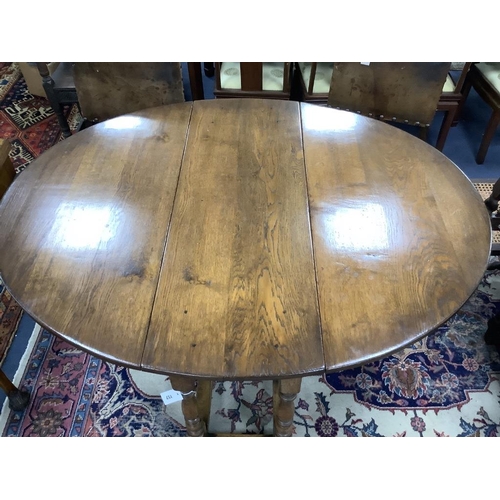 157 - An 18th century style oval oak gateleg dining table, length 150cm extended, width 122cm, height 75cm... 