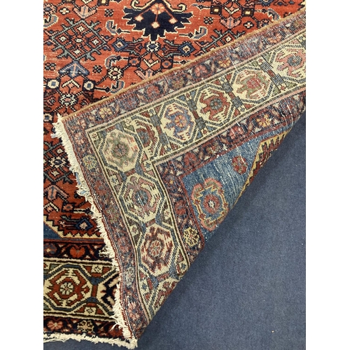 169 - A Caucasian Hamadan red ground rug, 220 x 136cm