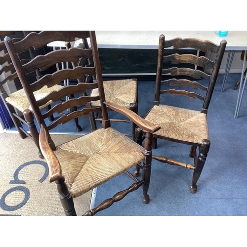 188 - A set of twelve ash rush seat ladder back dining chairs (two with arms)