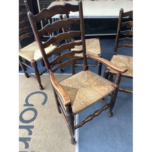 188 - A set of twelve ash rush seat ladder back dining chairs (two with arms)